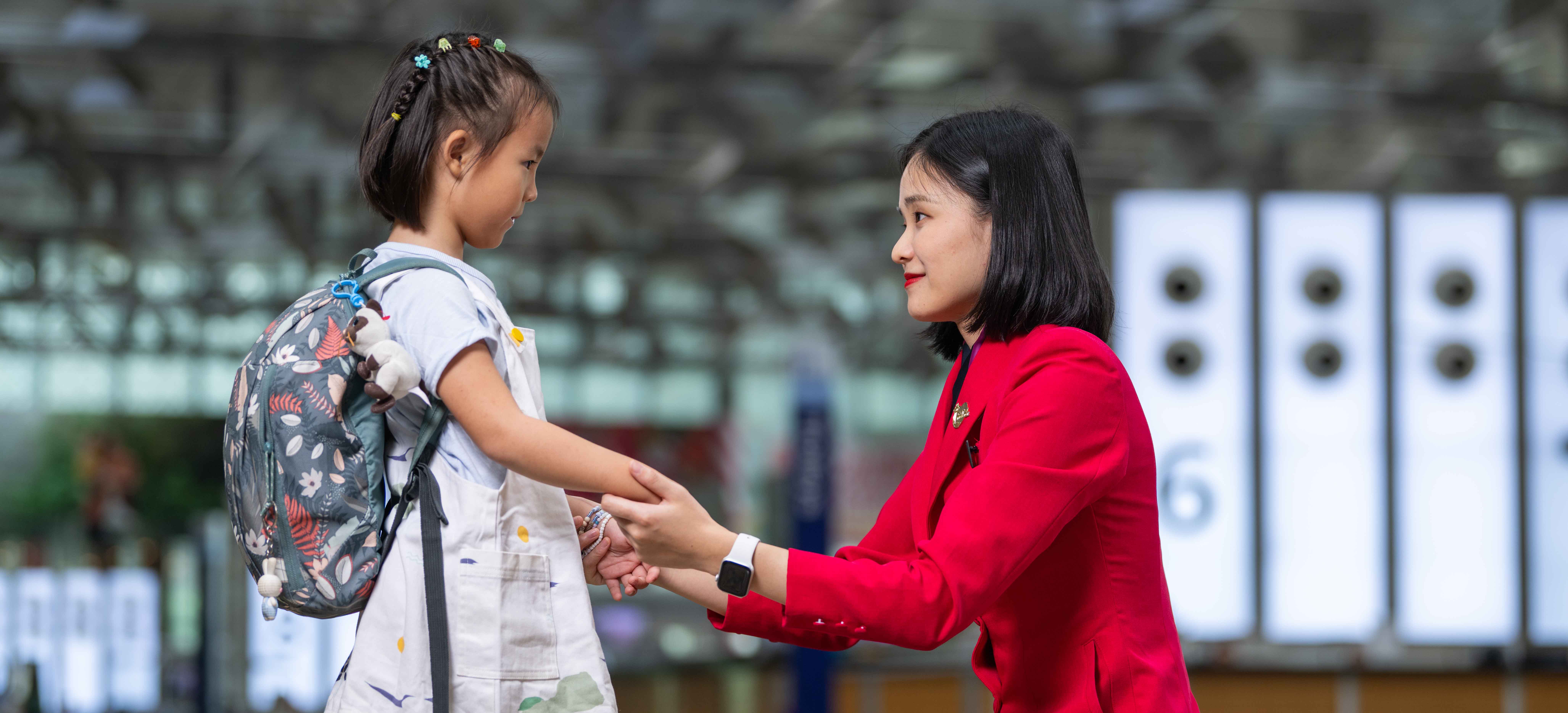 Changi Airport staff interacting with child