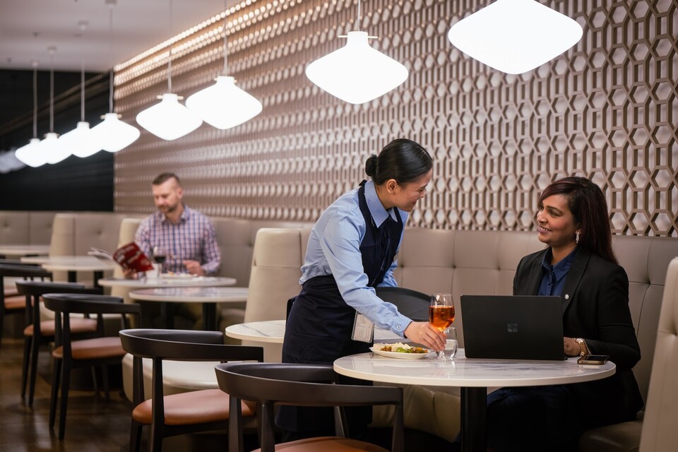 British Airways Lounge staff serving a guest