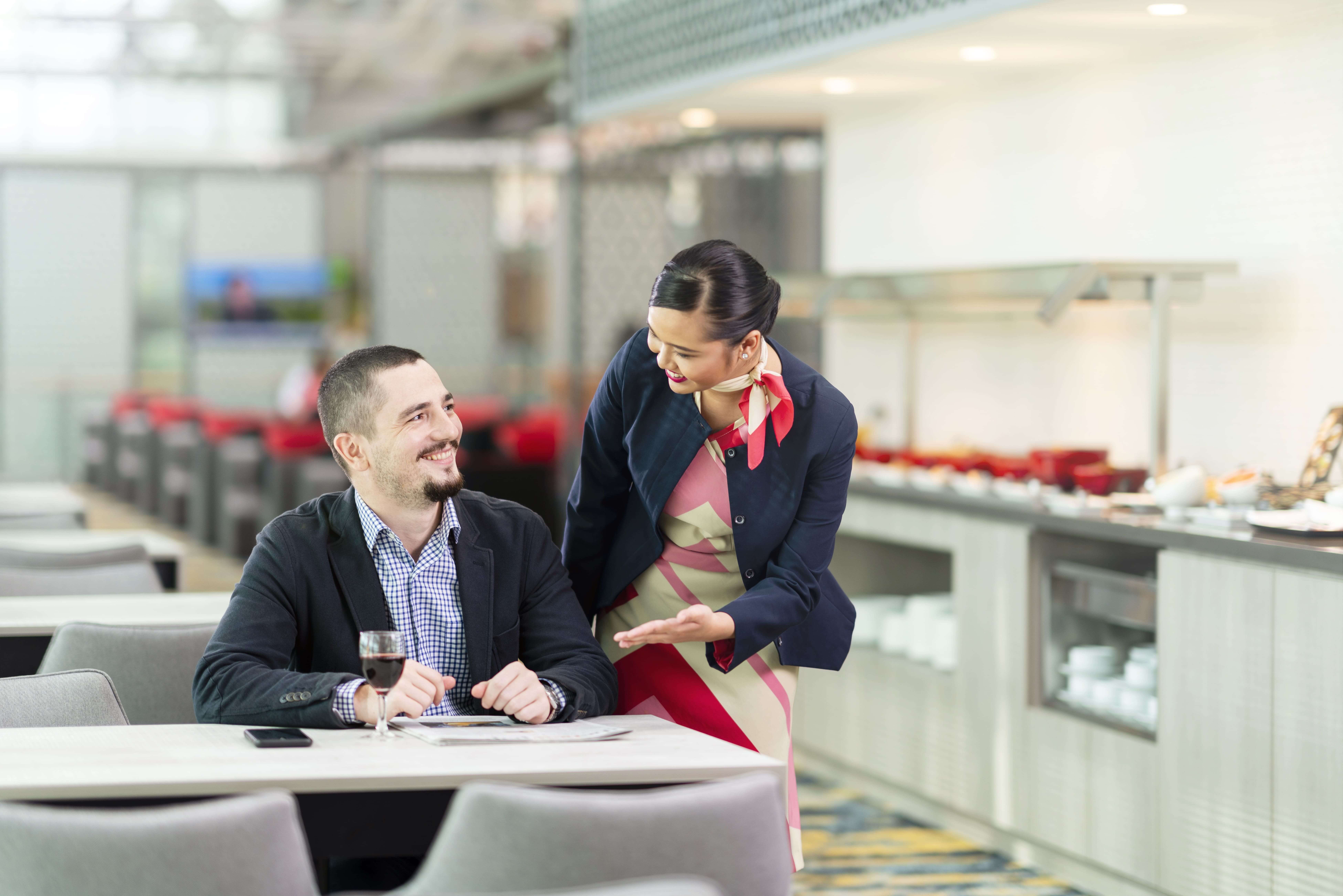 T3 Marhaba Lounge staff serving food to a guest