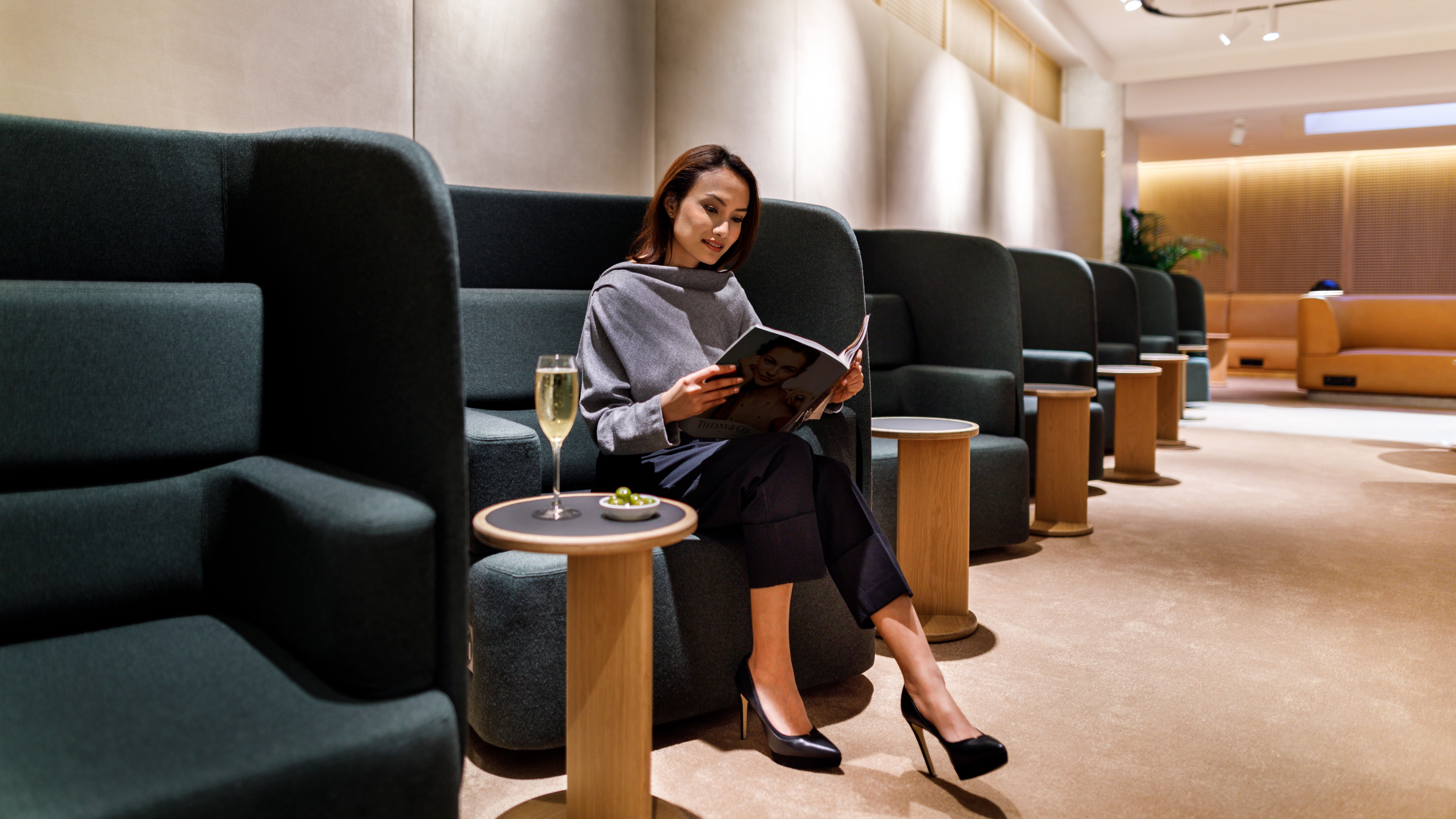 A guest relaxing Qantas First Lounge